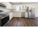 Kitchen featuring stainless steel appliances, white cabinets, and wood-look flooring at 105 Creekwood Ln, Fayetteville, GA 30214