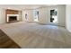 Spacious carpeted living room with a brick fireplace and views of the outdoors at 105 Creekwood Ln, Fayetteville, GA 30214