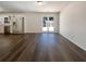 Open-concept living room with wood-look flooring and glass doors leading to backyard at 105 Creekwood Ln, Fayetteville, GA 30214