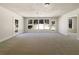 Open living room features neutral carpeting, large windows offering backyard views, and classic trim at 105 Creekwood Ln, Fayetteville, GA 30214