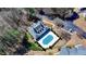 An aerial shot of the clubhouse building and covered outdoor pool surrounded by mature trees at 1535 Duluth Hwy # 1001, Lawrenceville, GA 30043