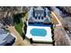 A building with a covered outdoor pool, surrounded by green landscaping and trees, taken from above at 1535 Duluth Hwy # 1001, Lawrenceville, GA 30043