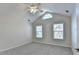 Bright bedroom with vaulted ceiling, carpeted floors, and two windows with backyard views at 1535 Duluth Hwy # 1001, Lawrenceville, GA 30043