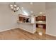 Bright dining area with hardwood floors, chandelier and open view into the kitchen with wood cabinets at 1535 Duluth Hwy # 1001, Lawrenceville, GA 30043