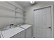 Laundry room with washer, dryer, and wire shelving for storage at 1535 Duluth Hwy # 1001, Lawrenceville, GA 30043