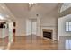 Open-concept living room with gleaming hardwood floors, fireplace, and a view into the kitchen at 1535 Duluth Hwy # 1001, Lawrenceville, GA 30043