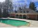 An in-ground pool on a sunny day, complete with ladder entry and surrounding buildings at 1535 Duluth Hwy # 1001, Lawrenceville, GA 30043