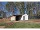 Backyard featuring a storage shed, trees, and black fencing at 2811 Birchwood Sw Ct, Marietta, GA 30060