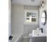 Updated bathroom with modern vanity, lighting, mirror and tub at 2811 Birchwood Sw Ct, Marietta, GA 30060