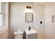 Bright bathroom featuring modern fixtures, a stylish mirror, and a toilet with neutral wall paint at 2811 Birchwood Sw Ct, Marietta, GA 30060
