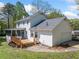 Expansive backyard featuring a wooden deck, screened porch, mature trees, and a well-maintained lawn at 3040 Wax Wing Nw Ct, Kennesaw, GA 30144