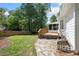 Backyard featuring a wooden deck, stone walkway, and a well-maintained lawn at 3040 Wax Wing Nw Ct, Kennesaw, GA 30144