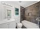 Modern bathroom featuring a shower with dark tiling and a white vanity at 3040 Wax Wing Nw Ct, Kennesaw, GA 30144