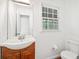 Bathroom with a stylish wood vanity and ample natural light from a window at 3040 Wax Wing Nw Ct, Kennesaw, GA 30144