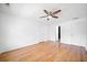 Bright bedroom features hardwood floors, a ceiling fan, and access to an ensuite bathroom at 3040 Wax Wing Nw Ct, Kennesaw, GA 30144