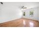 Bright bedroom features hardwood floors, two windows, and white walls at 3040 Wax Wing Nw Ct, Kennesaw, GA 30144