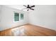 Bright bedroom features hardwood floors, white walls and a window with wooded view at 3040 Wax Wing Nw Ct, Kennesaw, GA 30144