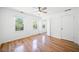 Bright bedroom with hardwood floors, two windows, and an open door at 3040 Wax Wing Nw Ct, Kennesaw, GA 30144