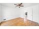 Bright bedroom featuring hardwood floors, a ceiling fan and view of the kitchen at 3040 Wax Wing Nw Ct, Kennesaw, GA 30144
