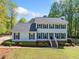 Traditional two-story home with a well-manicured lawn, brick foundation, and symmetrical window placement at 3040 Wax Wing Nw Ct, Kennesaw, GA 30144