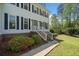 Close-up of a home's entrance, highlighting the brick foundation, landscaped bushes and stairs to front door at 3040 Wax Wing Nw Ct, Kennesaw, GA 30144