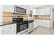 Well-lit kitchen features stainless steel appliances, and white cabinets at 3040 Wax Wing Nw Ct, Kennesaw, GA 30144
