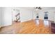 Expansive living room with hardwood floors, a staircase, and natural light from large windows at 3040 Wax Wing Nw Ct, Kennesaw, GA 30144
