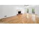 Spacious living room with gleaming hardwood floors, fireplace, and large windows for natural light at 3040 Wax Wing Nw Ct, Kennesaw, GA 30144