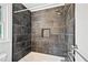Close-up of a modern shower with dark gray tile and a built-in niche at 3040 Wax Wing Nw Ct, Kennesaw, GA 30144