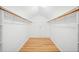 Spacious walk-in closet with hardwood floors, built-in shelving, and wooden rails at 3040 Wax Wing Nw Ct, Kennesaw, GA 30144