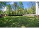 Large, level yard with mature trees and a wooden fence creating a private outdoor space at 3040 Wax Wing Nw Ct, Kennesaw, GA 30144