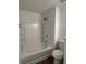 Bathroom featuring a white bathtub with tile surround, a showerhead, and wood-look floors at 358 Azalea Cir, Cumming, GA 30040