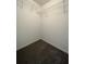 Walk-in closet featuring wire shelving and neutral carpet at 358 Azalea Cir, Cumming, GA 30040