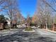 Gated Wynngate entrance offering privacy and security with mature trees and landscaping at 358 Azalea Cir, Cumming, GA 30040