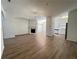 Bright living room with fireplace, modern light fixture, and wood floors at 358 Azalea Cir, Cumming, GA 30040