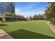 Large, open greenspace with building and tall trees in background at 10 Perimeter Summit # 2402, Atlanta, GA 30319