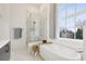 Luxurious bathroom with a soaking tub, glass-enclosed shower, and large window at 1200 Ponce De Leon Ne Ave # A1, Atlanta, GA 30306
