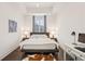 Bright bedroom with hardwood floors, a plush bed, and a dedicated workspace at 1200 Ponce De Leon Ne Ave # A1, Atlanta, GA 30306