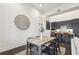 Open dining room with modern light fixture, table, and seating near the kitchen at 1200 Ponce De Leon Ne Ave # A1, Atlanta, GA 30306