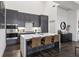 Modern kitchen with stainless steel appliances, quartz countertops, and breakfast bar at 1200 Ponce De Leon Ne Ave # A1, Atlanta, GA 30306