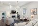 Bright, open living room with modern lighting, fireplace, and large windows at 1200 Ponce De Leon Ne Ave # A1, Atlanta, GA 30306