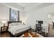 Bright main bedroom featuring a workstation, dark wood floors, tray ceilings, and a large window at 1200 Ponce De Leon Ne Ave # A1, Atlanta, GA 30306