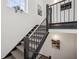 Carpeted staircase with black railing featuring artwork on the walls at 1200 Ponce De Leon Ne Ave # A1, Atlanta, GA 30306