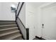 Carpeted staircase with black railing leading up to the second floor at 1200 Ponce De Leon Ne Ave # A1, Atlanta, GA 30306
