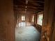 Living room featuring exposed beams, windows, and hardwood floors awaiting remodeling at 1713 Cahoon St, Atlanta, GA 30310