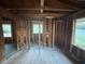 Living room featuring exposed beams, windows, and hardwood floors awaiting remodeling at 1713 Cahoon St, Atlanta, GA 30310