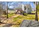 Lush backyard with deck, hot tub, and mature trees, perfect for outdoor entertaining and relaxation at 52 Newman Dr, Villa Rica, GA 30180