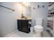 Compact bathroom featuring a vanity with storage, toilet, and shower with stylish curtain at 52 Newman Dr, Villa Rica, GA 30180