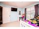 Well-lit bedroom featuring light blue walls, a window, and a TV at 52 Newman Dr, Villa Rica, GA 30180