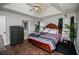 Spacious bedroom with a wooden bed frame, wood floors, a ceiling fan and natural light at 52 Newman Dr, Villa Rica, GA 30180